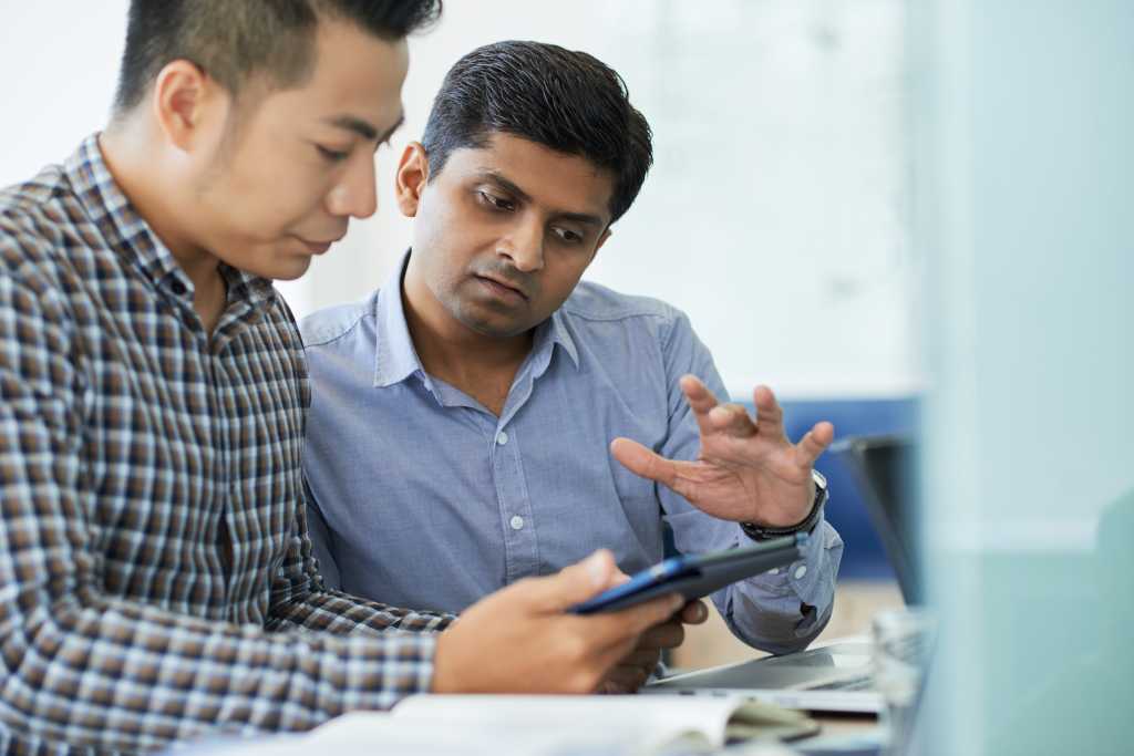 Mobile app developer showing test version of product to team lead