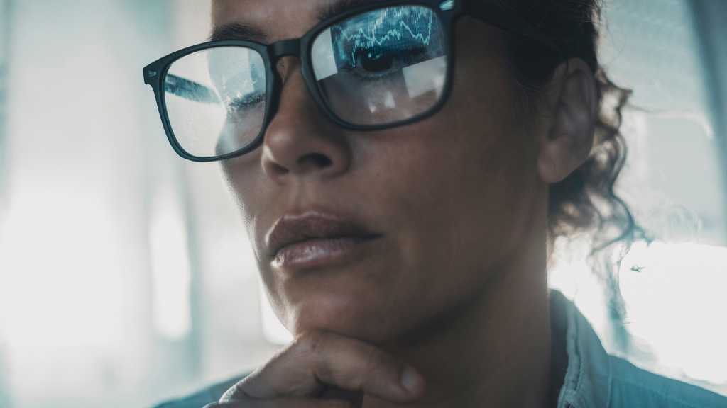 data reflecting on woman’s glasses